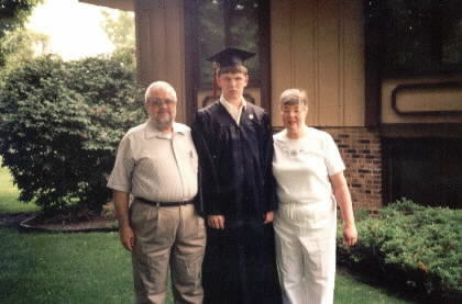 Mike in robes with parents